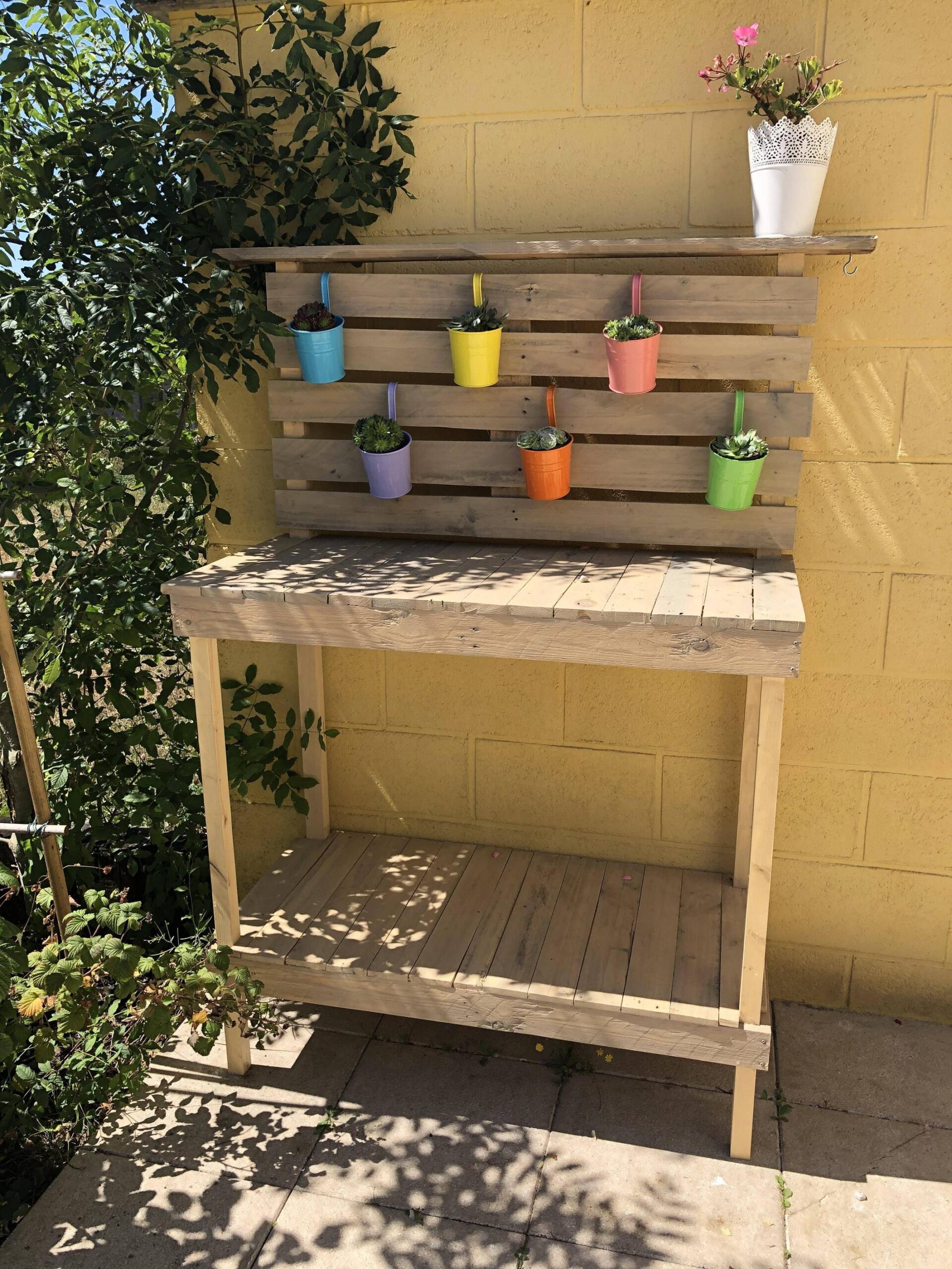 A potting bench made out of pallet wood